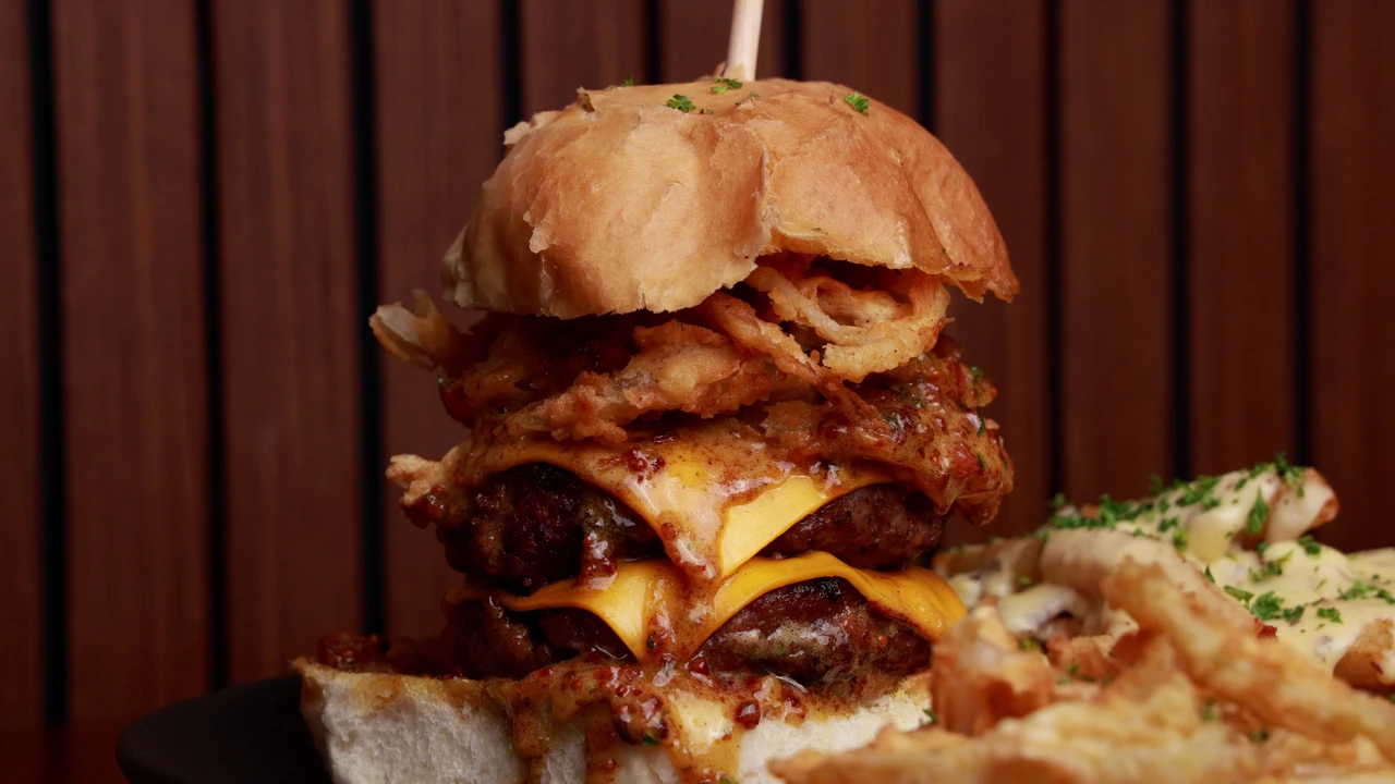 A Red Oak burger platter with bicep fries, cheesy fries and crispy onion rings.