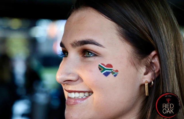 A guest with a South African flag painted on her cheek.