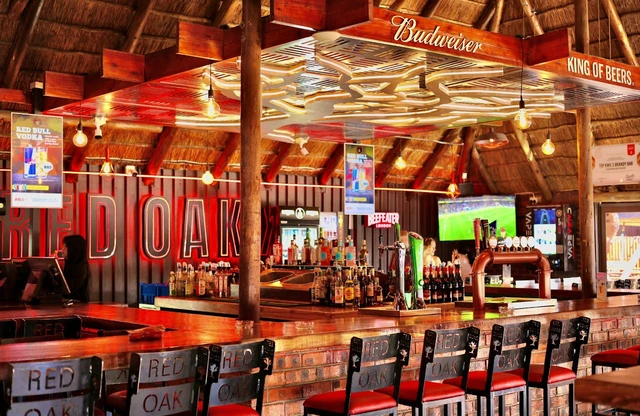 The Red Oak bar under the Budweiser light rig and thatch roof.