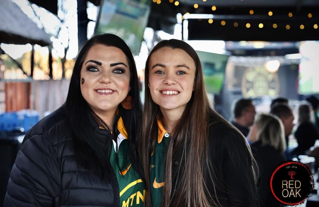 Two guests in rugby supporters' shirts at an event.