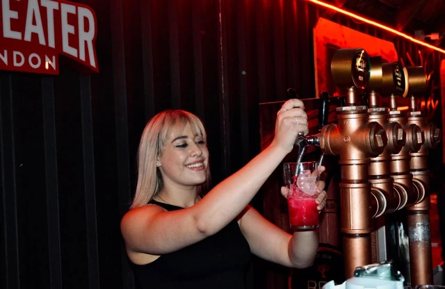 A bartender making a cocktail at the Beefeater-branded bar.