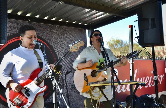 Two musicians performing an acoustic set at Red Oak.