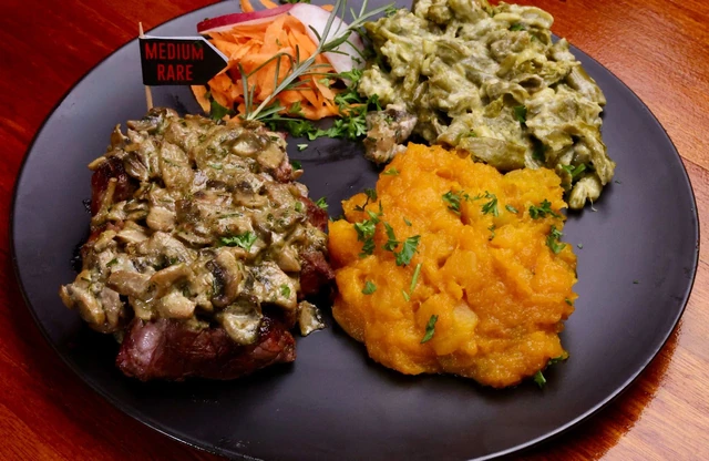A Red Oak plate of meat with butternut and creamed vegetables.