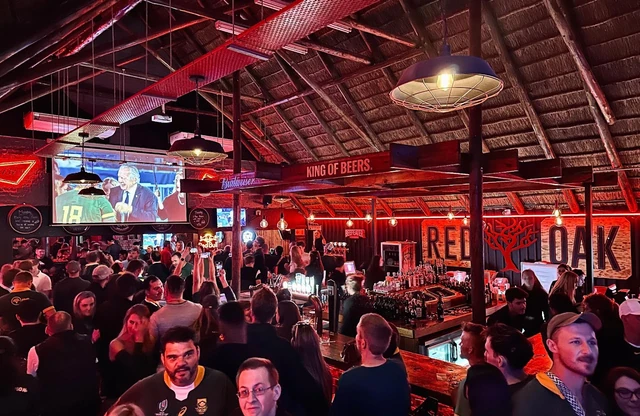 A full house watching rugby on the screens under the thatch roof.